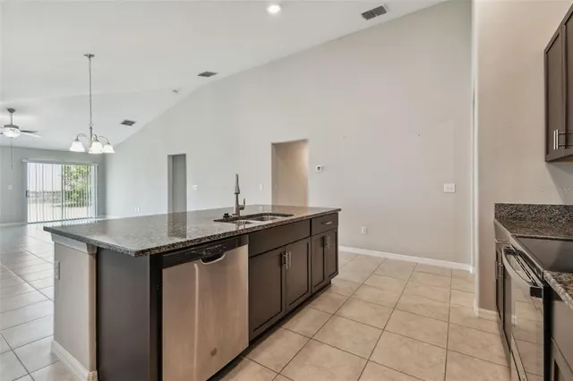 a kitchen with a refrigerator and a sink