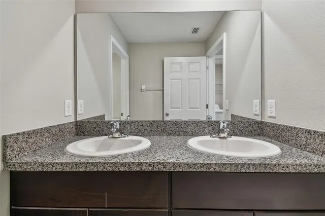 an aerial view of residential houses with lake view and mountain view in back