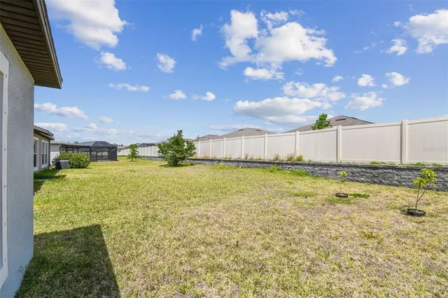 an aerial view of a house with a swimming pool outdoor seating and yard