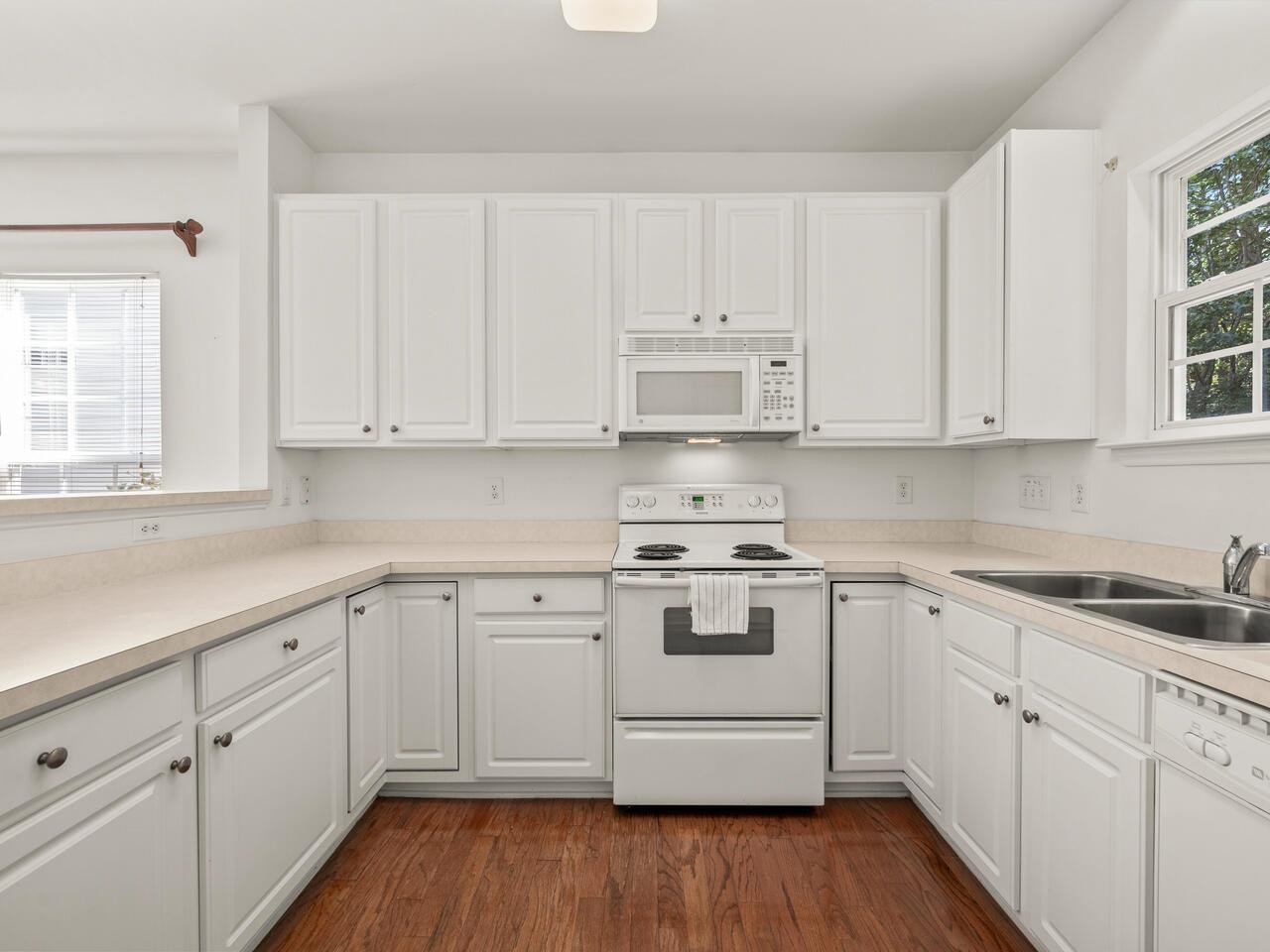 8425 Lunar Stone Place Raleigh, NC 27613 - Photo 11 of 34 a white kitchen with sink and cabinets