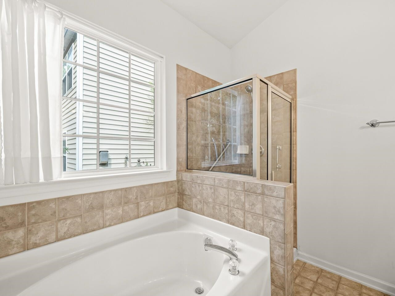 8425 Lunar Stone Place Raleigh, NC 27613 - Photo 24 of 34 a bathroom with a bathtub and a window