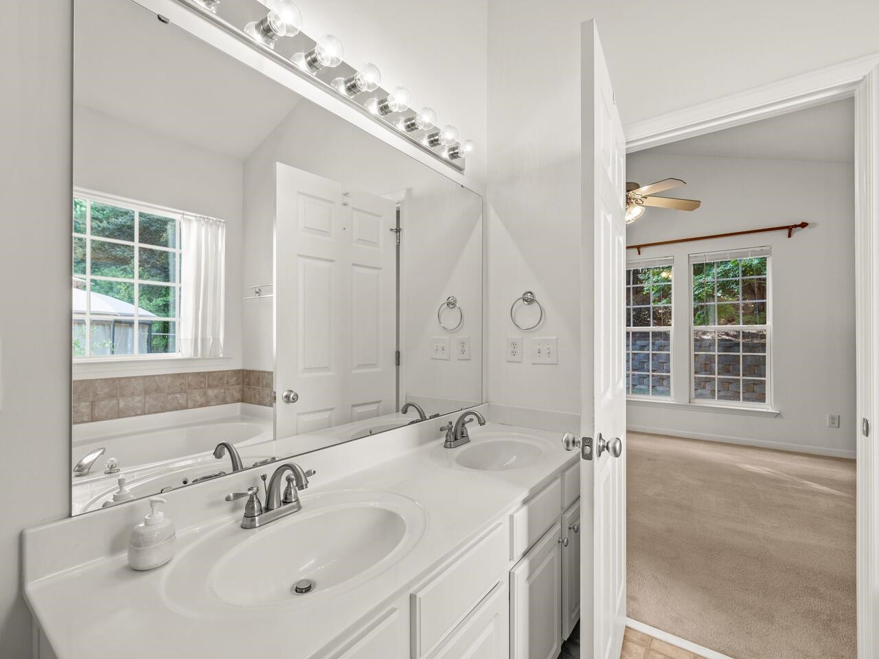 8425 Lunar Stone Place Raleigh, NC 27613 - Photo 25 of 34 a bathroom with a sink and a mirror