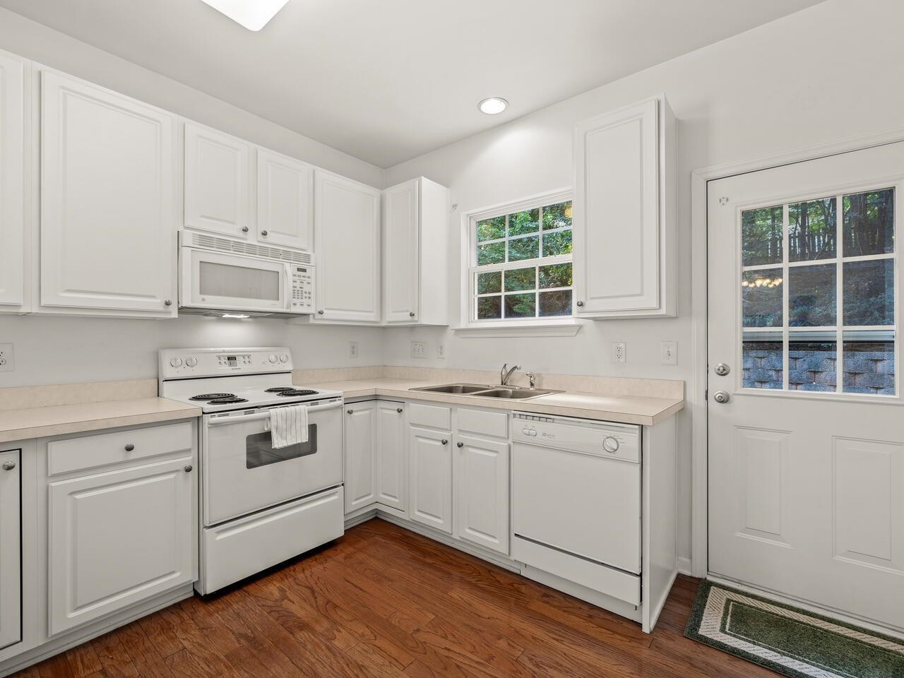 8425 Lunar Stone Place Raleigh, NC 27613 - Photo 8 of 34 a kitchen with granite countertop white cabinets and white appliances