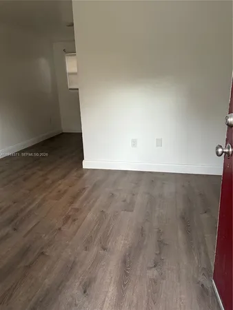 an empty room with wooden floor
