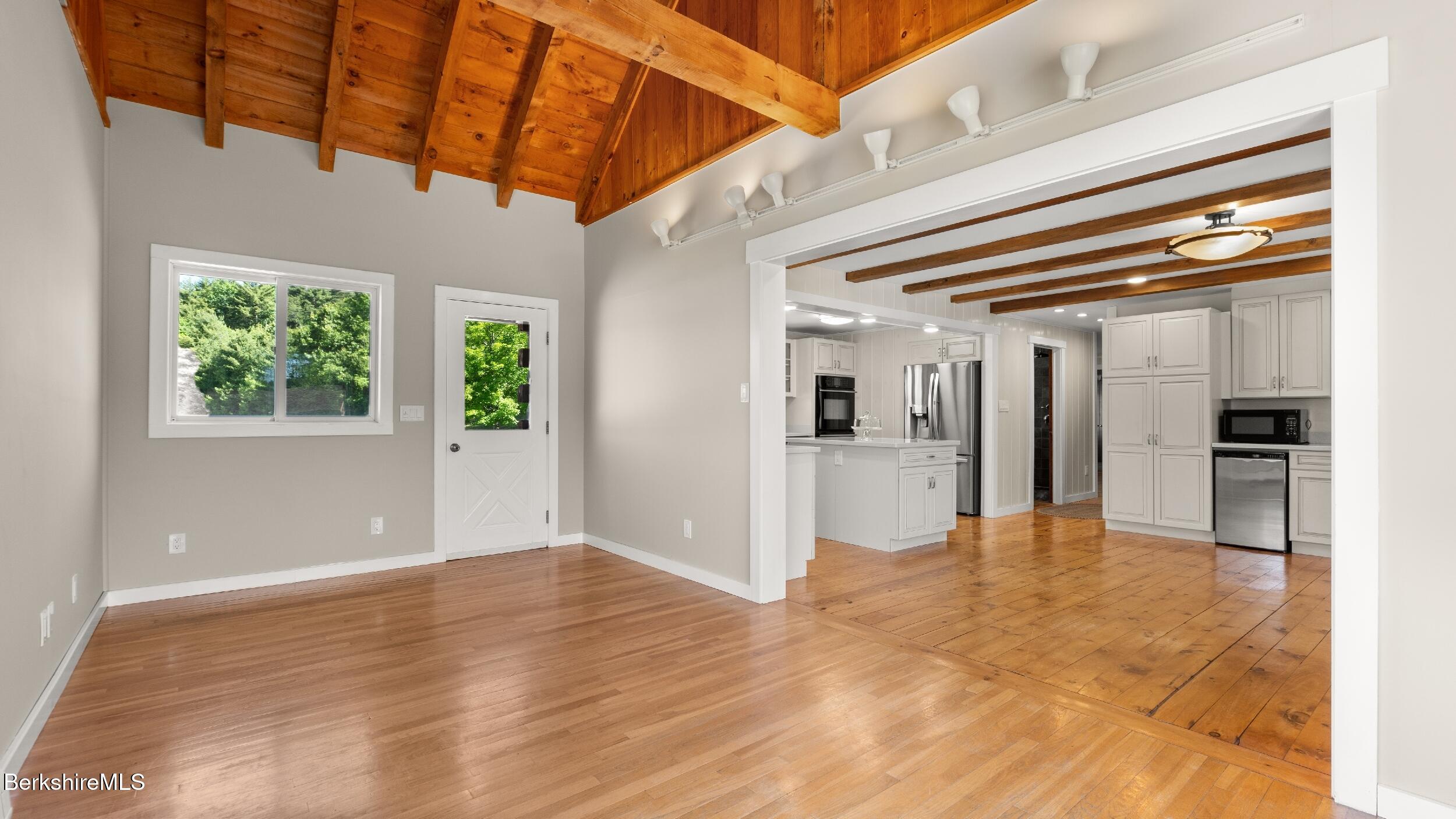 134 Hurlburt Road Great Barrington, MA 01230 - Photo 13 of 50 a view of empty room with wooden floor and windows