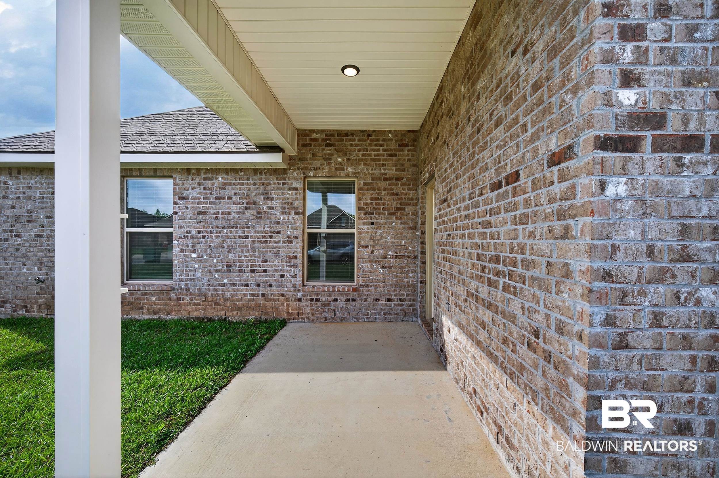 1084 Stella Road Foley, AL 36535 - Photo 28 of 31 Doorway to property with a patio, brick siding, and a shingled roof