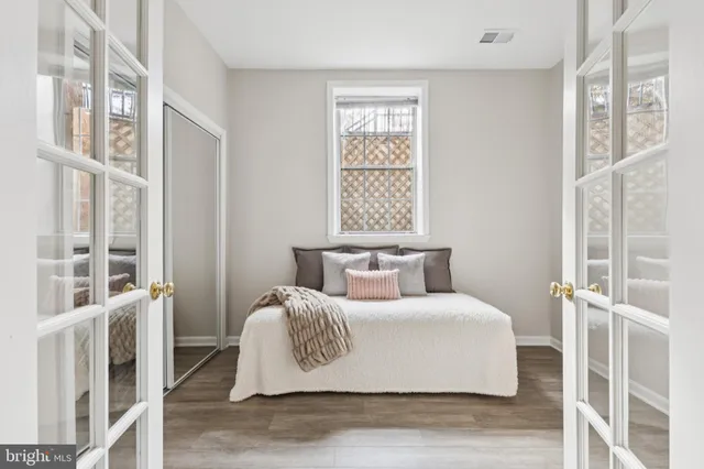 a bedroom with a large bed and a window