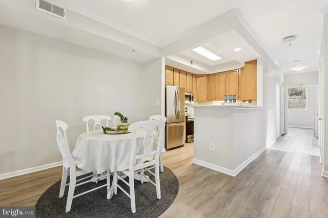 a view of a dining room with furniture and wooden floor