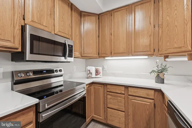 a kitchen with granite countertop a stove microwave and sink