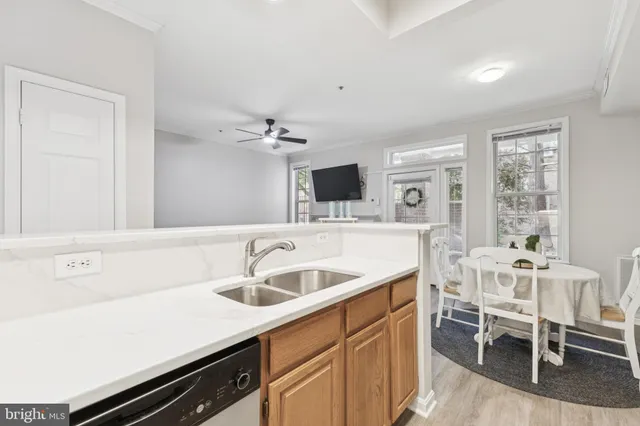 a kitchen with a sink cabinets and window