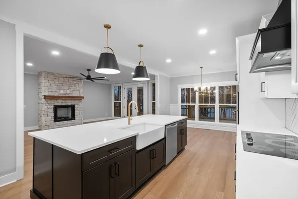 a kitchen with a sink a center island and stainless steel appliances