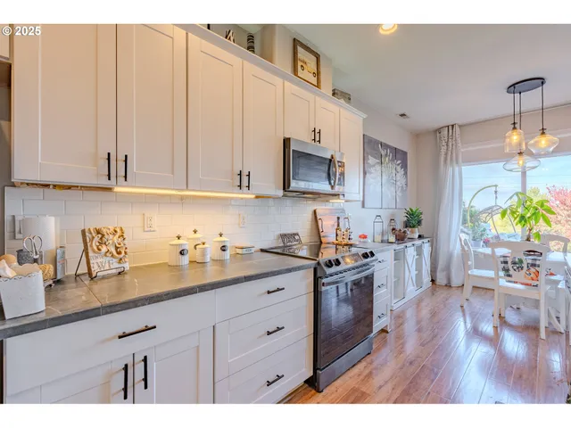 a kitchen with sink cabinets and wooden floor