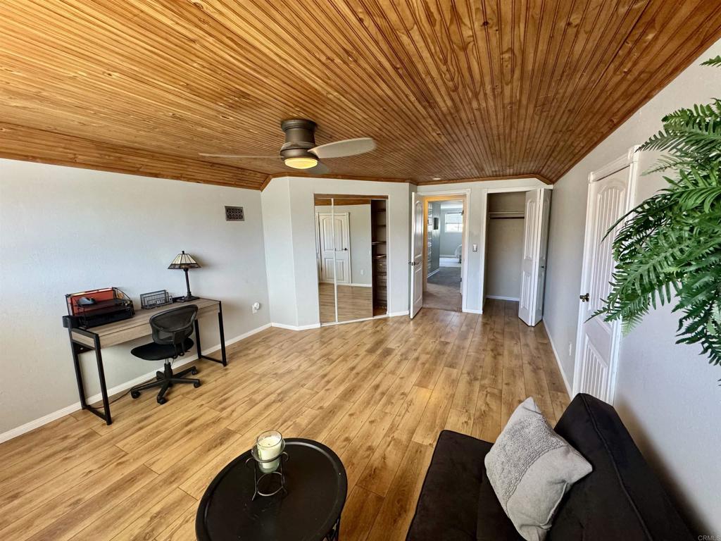 12443 Danes Road Poway, CA 92064 - Photo 27 of 44 a bedroom with a bed and a potted plant