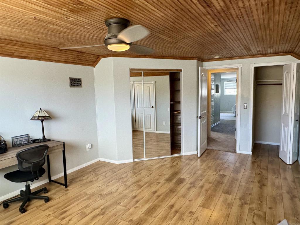 12443 Danes Road Poway, CA 92064 - Photo 40 of 44 a view of a room with wooden floor and ceiling fan