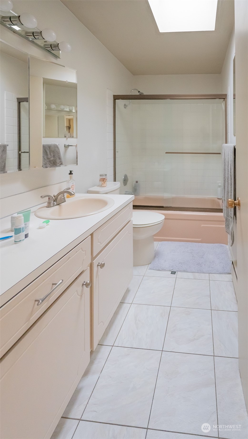 15 Ward Street Seattle, WA 98109 - Photo 12 of 17 a spacious bathroom with a granite countertop sink a mirror and a bathtub