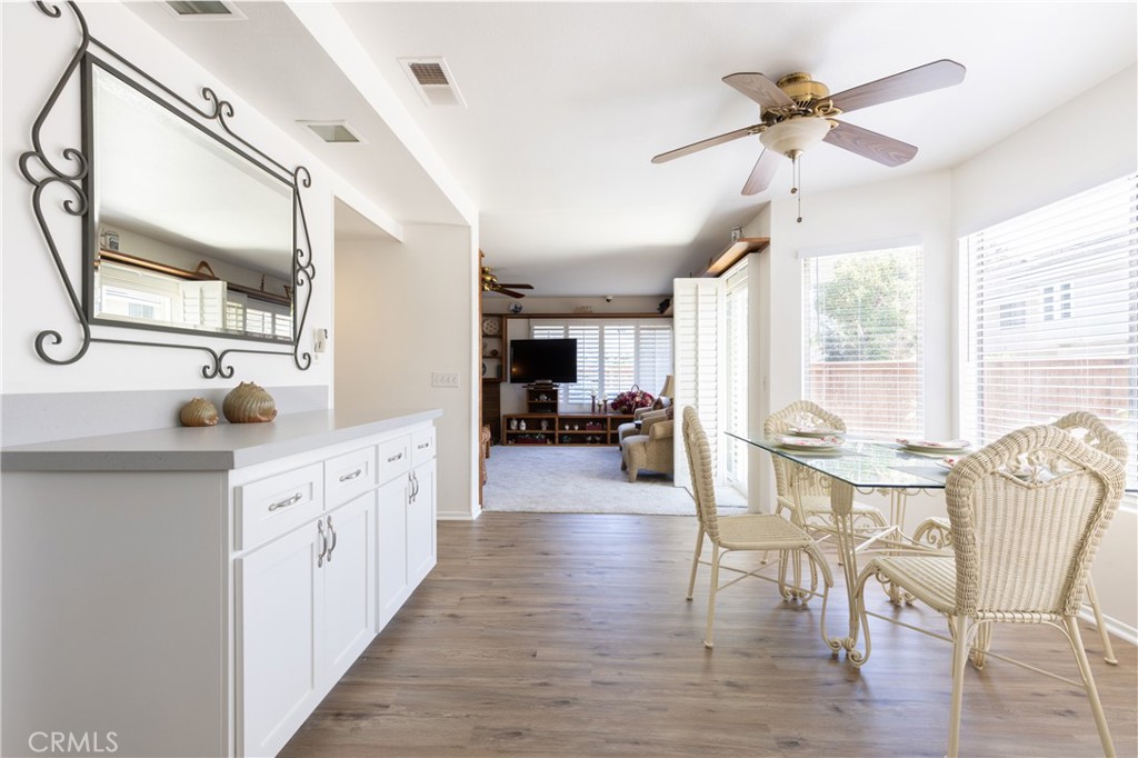94 Wildwood, Unit 11 Irvine, CA 92604 - Photo 13 of 41 a large kitchen with stainless steel appliances a table chairs refrigerator and cabinets