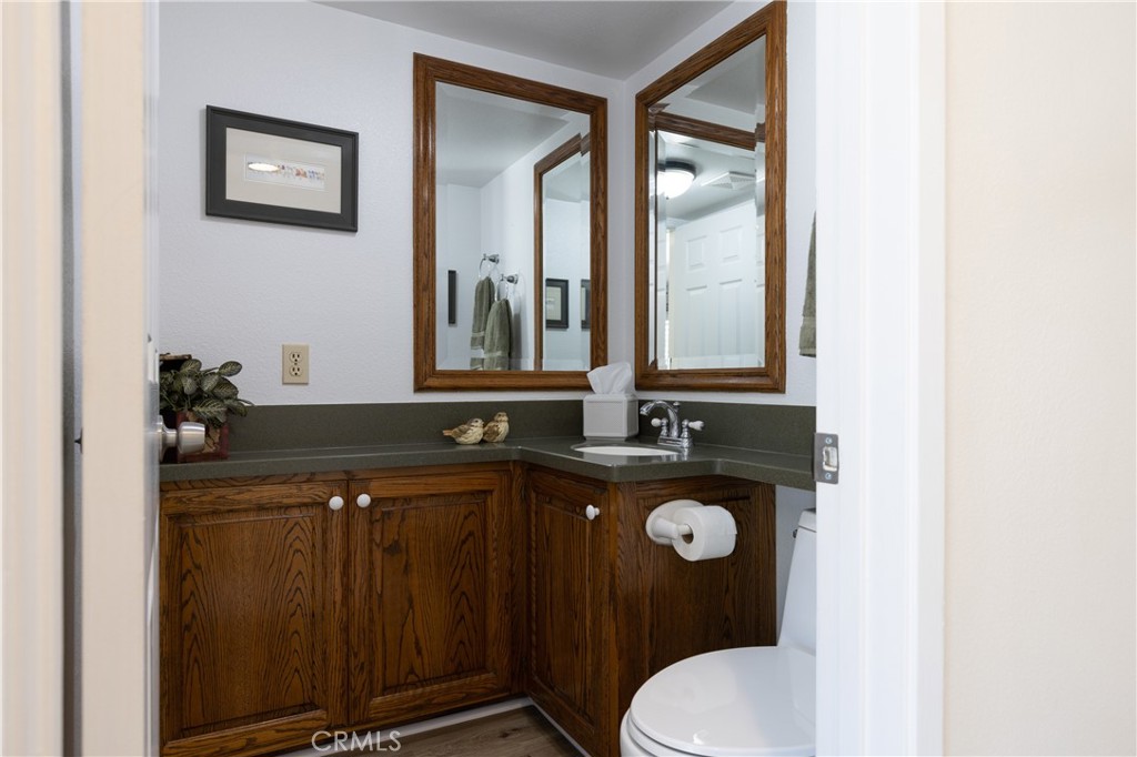 94 Wildwood, Unit 11 Irvine, CA 92604 - Photo 18 of 41 a bathroom with a granite countertop sink toilet and mirror
