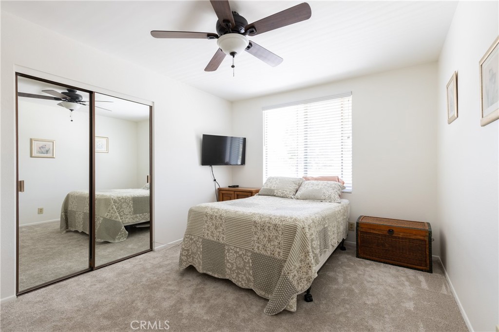 94 Wildwood, Unit 11 Irvine, CA 92604 - Photo 19 of 41 a bedroom with a bed and a flat tv screen