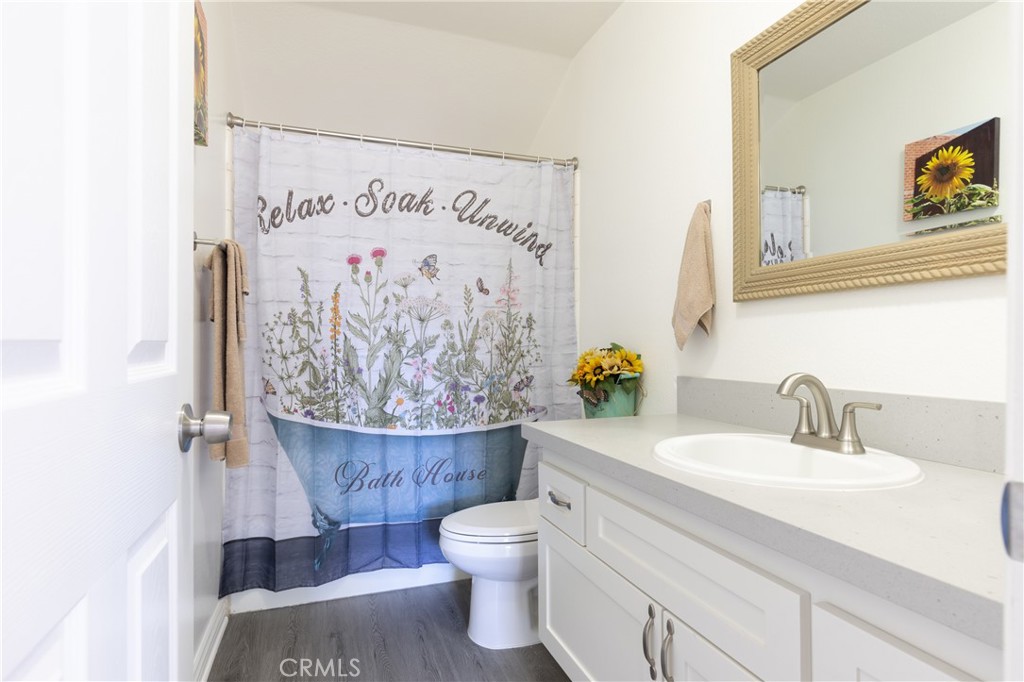 94 Wildwood, Unit 11 Irvine, CA 92604 - Photo 22 of 41 a bathroom with a toilet a sink and a shower curtain