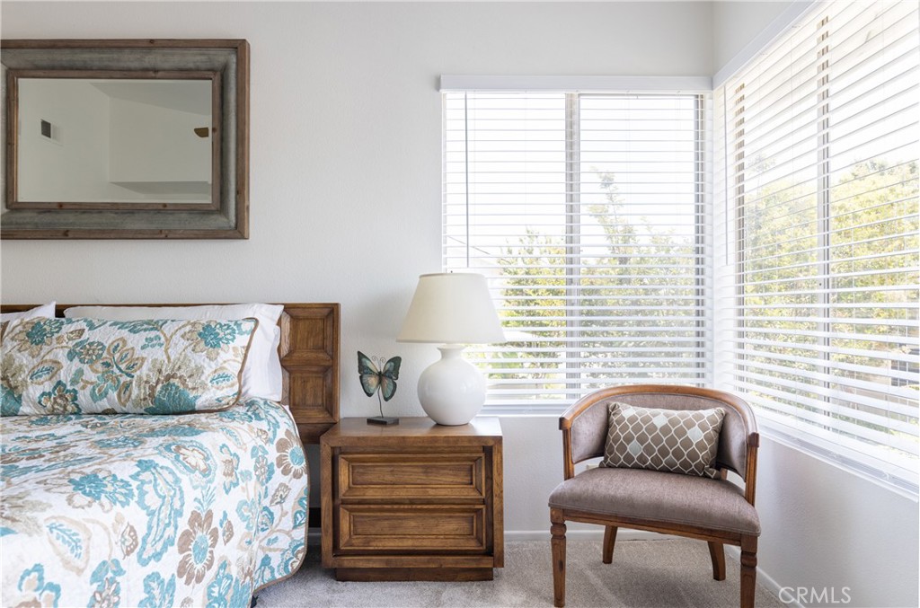 94 Wildwood, Unit 11 Irvine, CA 92604 - Photo 26 of 41 a bedroom with furniture and a window
