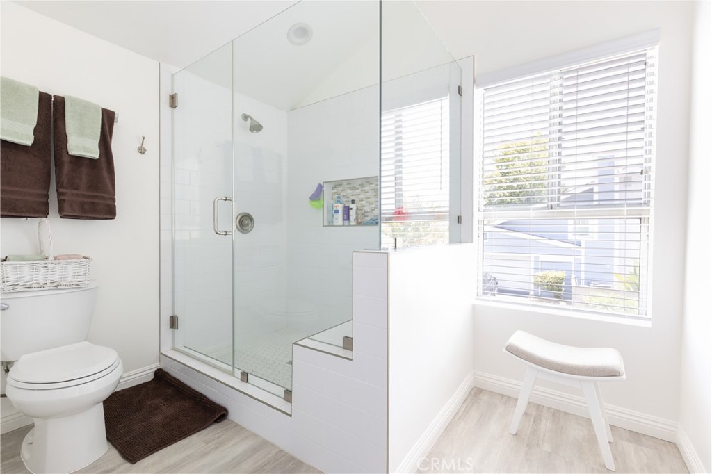 94 Wildwood, Unit 11 Irvine, CA 92604 - Photo 30 of 41 a bathroom with a toilet a sink and a shower