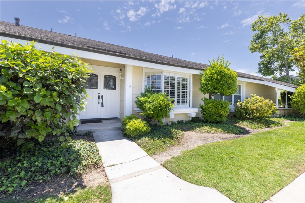 94 Wildwood, Unit 11 Irvine, CA 92604 - Photo 36 of 41 a front view of a house with garden