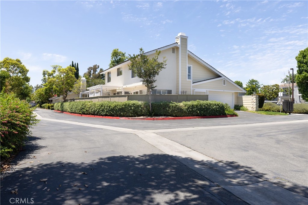94 Wildwood, Unit 11 Irvine, CA 92604 - Photo 38 of 41 a front view of a house with a yard and garage