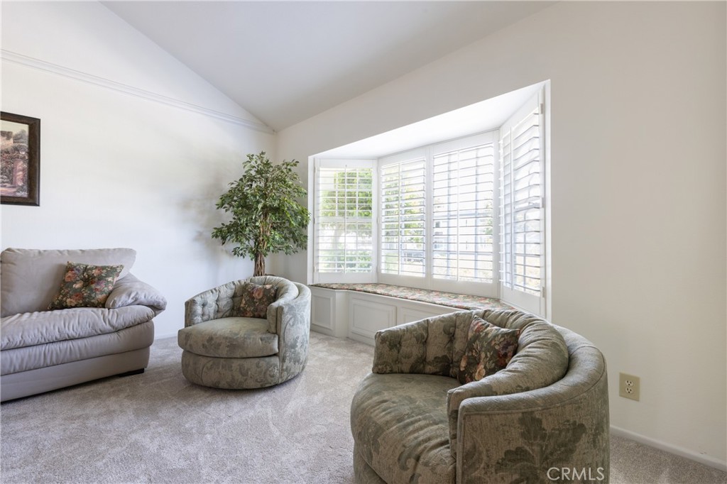 94 Wildwood, Unit 11 Irvine, CA 92604 - Photo 4 of 41 a living room with furniture and a large window