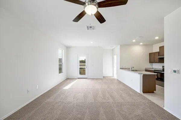 a view of kitchen with stove and refrigerator