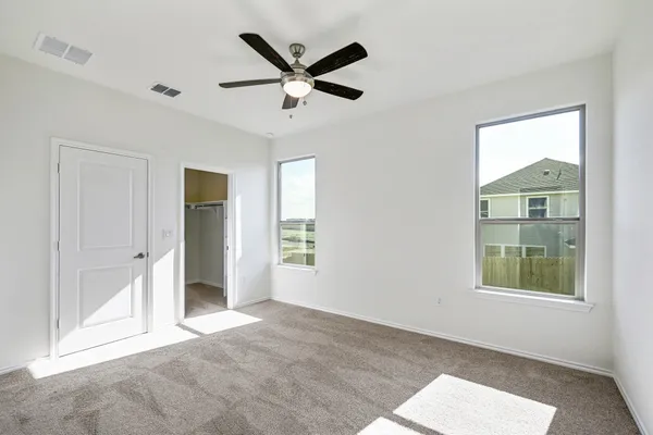a view of a livingroom with a ceiling fan and window