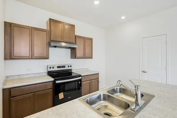 a kitchen that has a sink and a stove