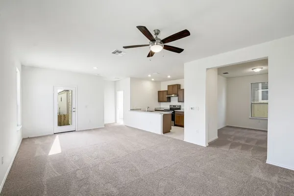 a view of a kitchen with a sink and a refrigerator