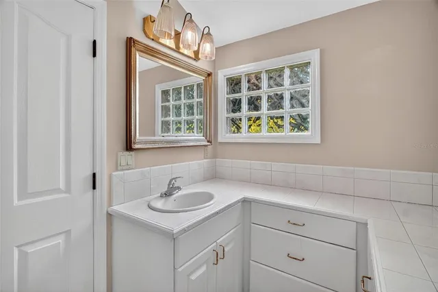 a view of a hallway with wooden floor and a living room