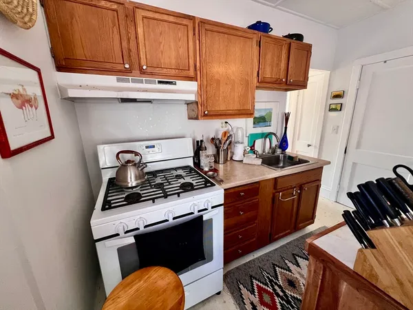 a kitchen with stainless steel appliances granite countertop a stove and a refrigerator