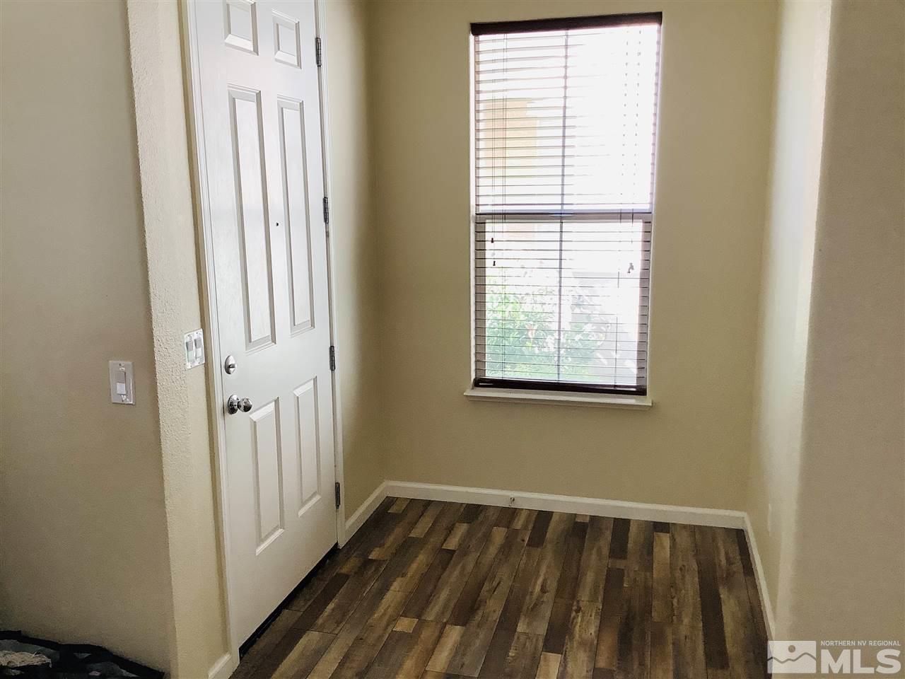 9375 Hummer Court Reno, NV 89521 - Photo 11 of 23 a view of a room with wooden floor and a window
