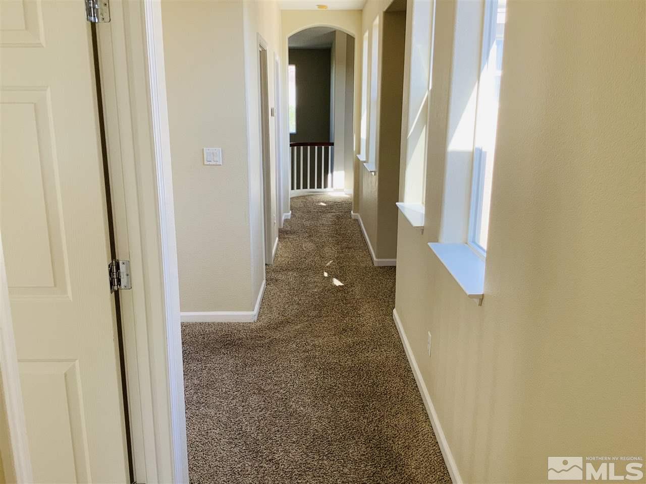 9375 Hummer Court Reno, NV 89521 - Photo 16 of 23 a view of a hallway with wooden floor and entryway