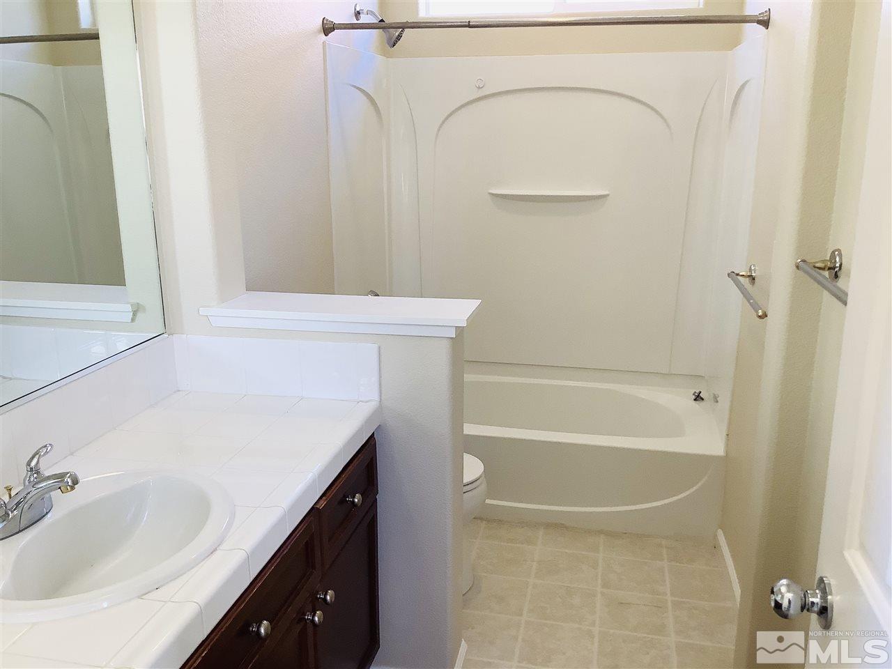 9375 Hummer Court Reno, NV 89521 - Photo 17 of 23 a bathroom with a sink a vanity and a bathtub