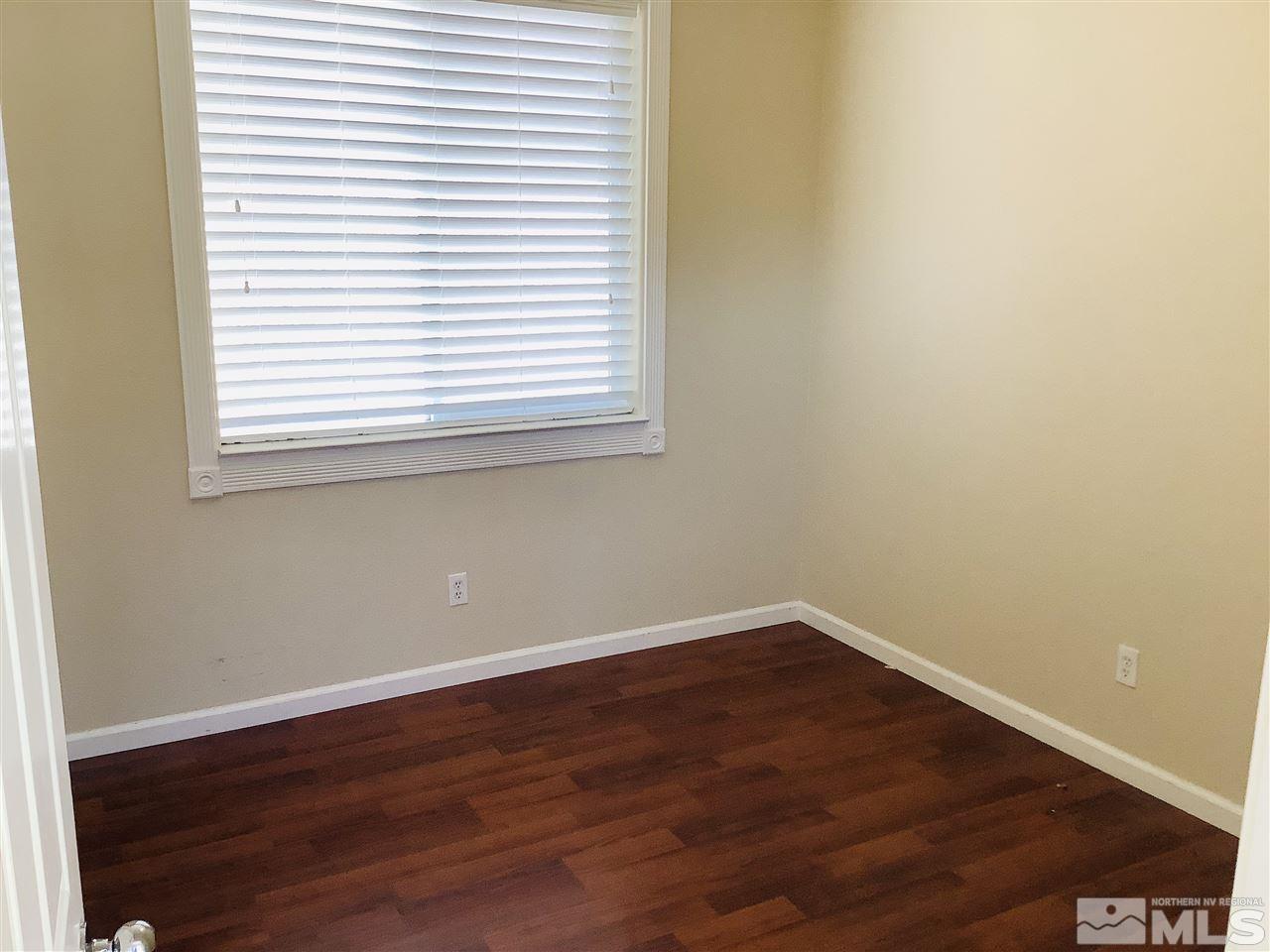 9375 Hummer Court Reno, NV 89521 - Photo 18 of 23 an empty room with wooden floor and a window