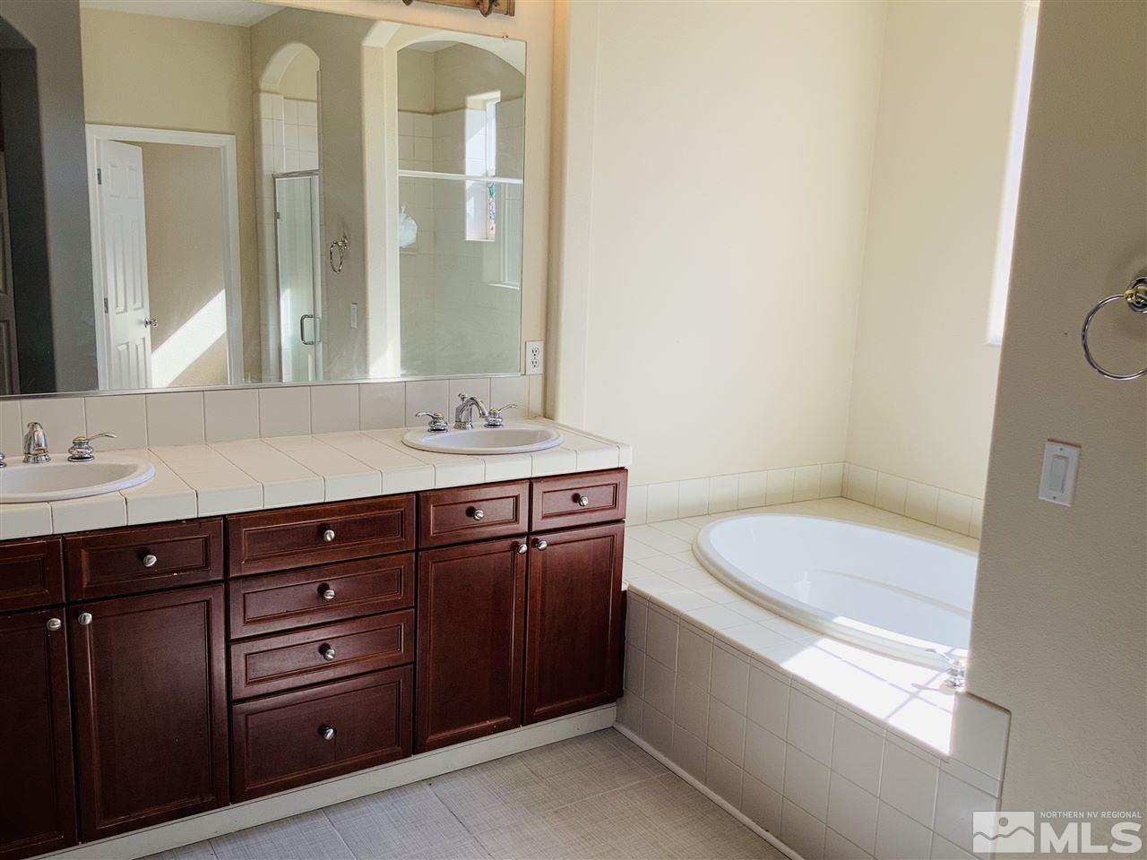 9375 Hummer Court Reno, NV 89521 - Photo 19 of 23 a bathroom with a sink and a mirror