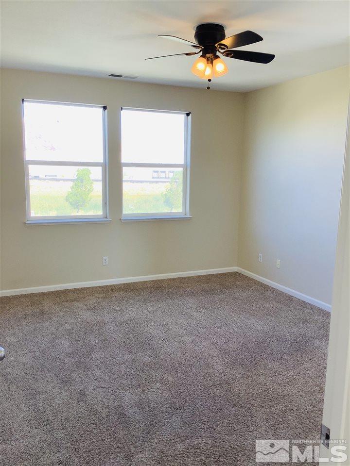 9375 Hummer Court Reno, NV 89521 - Photo 21 of 23 an empty room with windows and fan