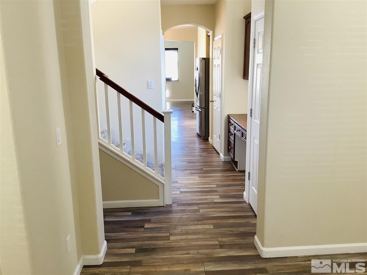 9375 Hummer Court Reno, NV 89521 - Photo 23 of 23 a view of a hallway with wooden floor and staircase