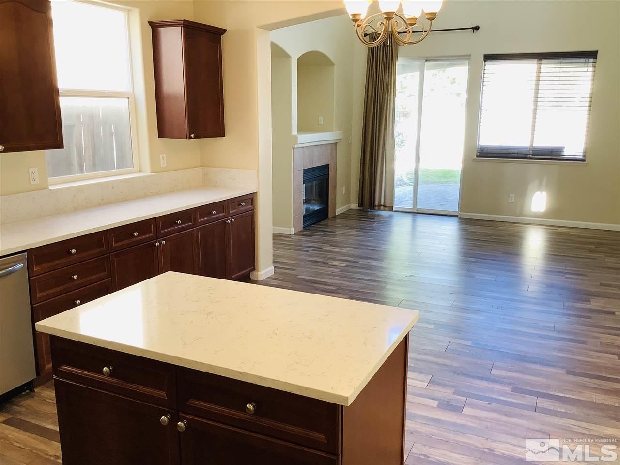 9375 Hummer Court Reno, NV 89521 - Photo 4 of 23 a kitchen with a wooden floor and a large window