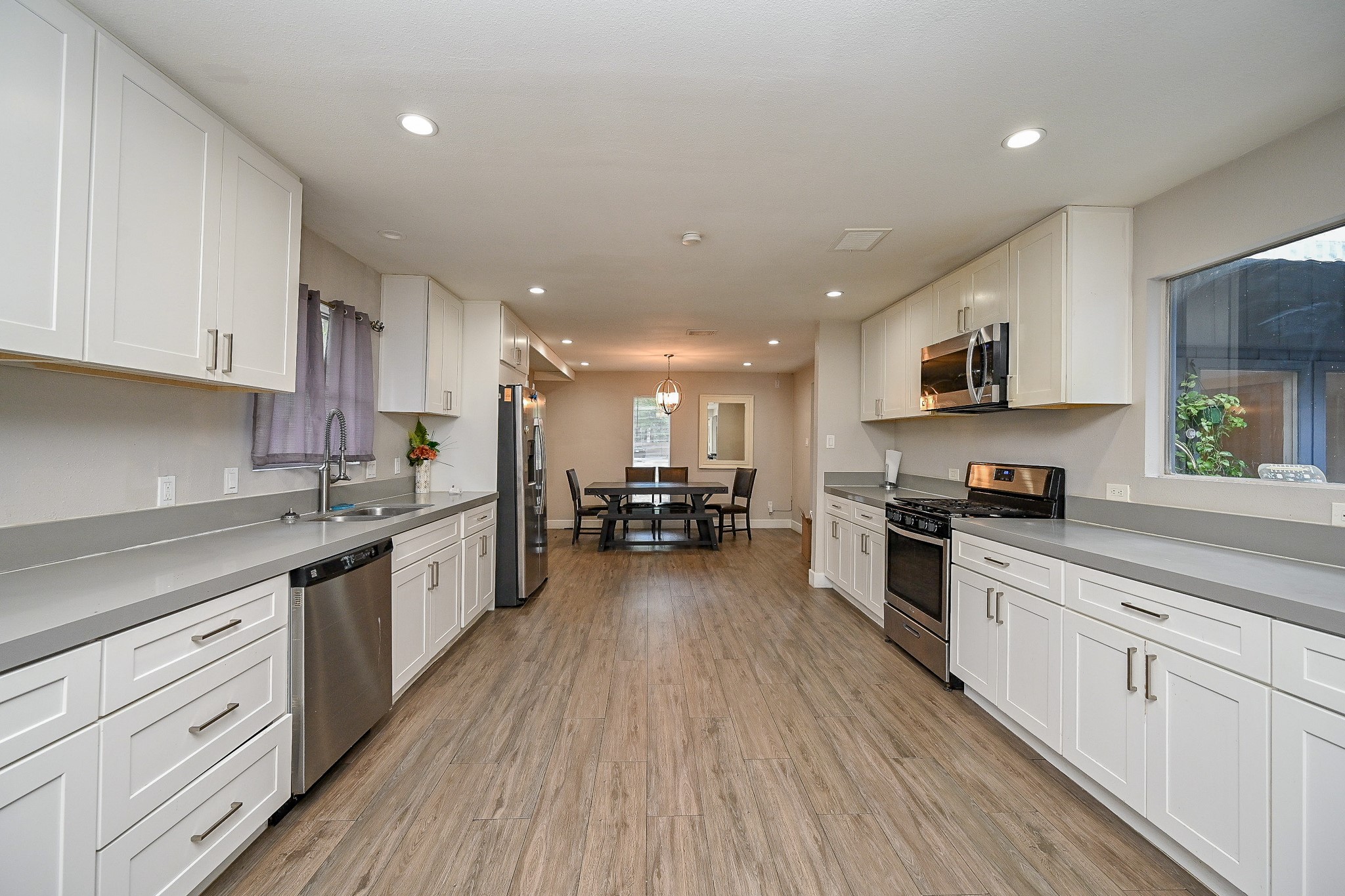 2406 Encreek Road Houston, TX 77068 - Photo 11 of 25 a large kitchen with stainless steel appliances granite countertop a lot of counter space and wooden floors