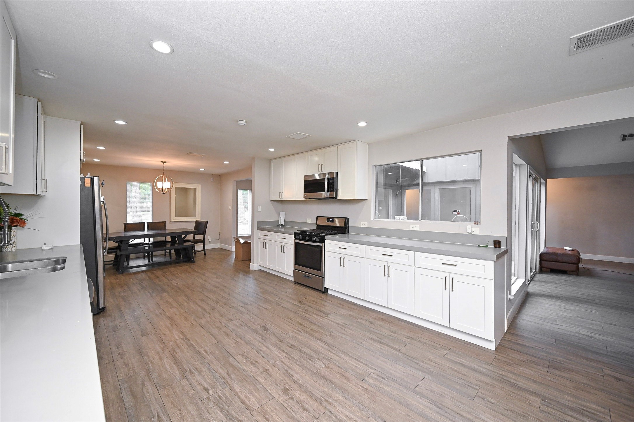 2406 Encreek Road Houston, TX 77068 - Photo 12 of 25 a kitchen with sink a microwave and cabinets