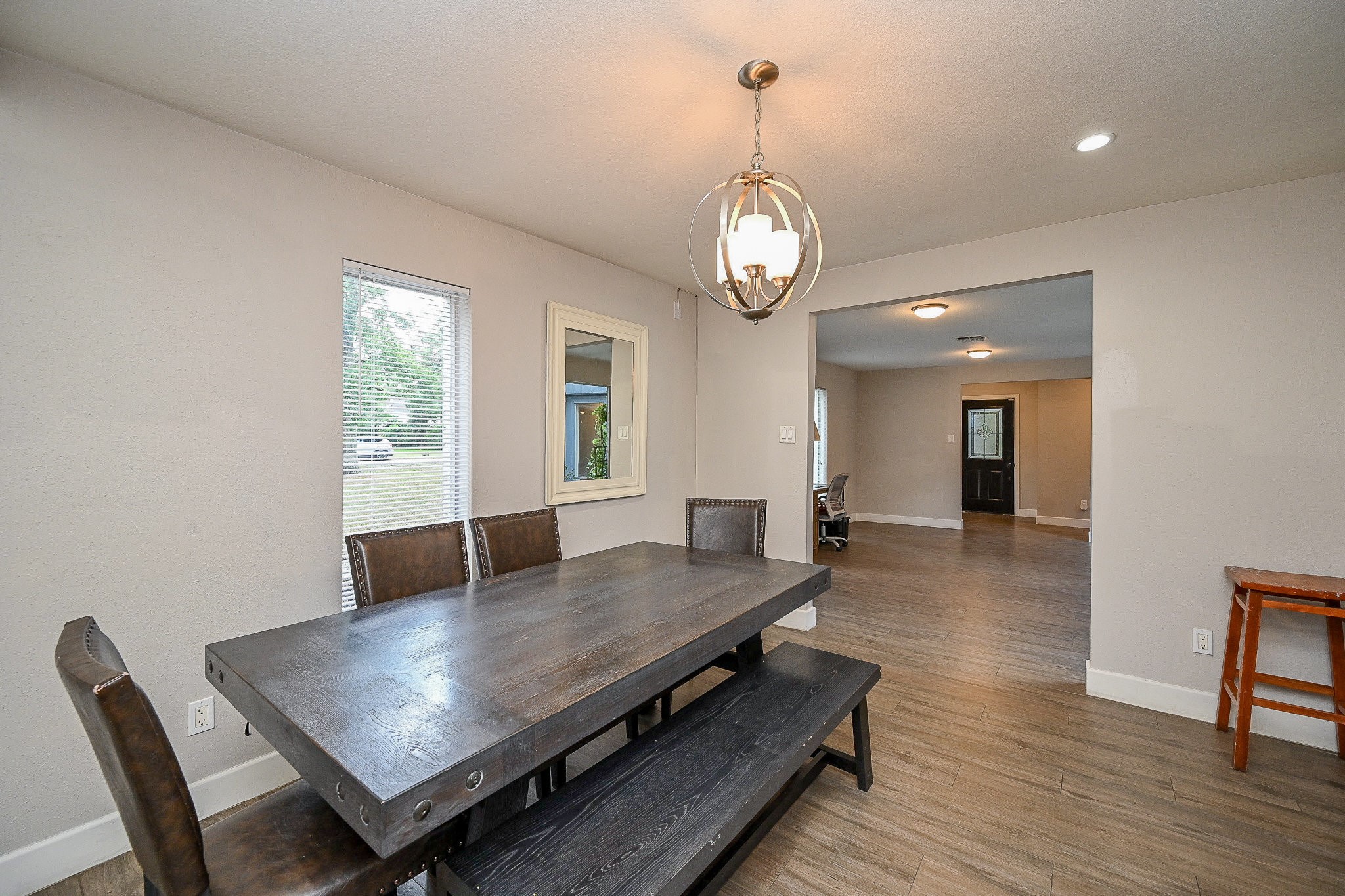 2406 Encreek Road Houston, TX 77068 - Photo 9 of 25 a view of a dining room and livingroom with furniture wooden floor a rug and a chandelier