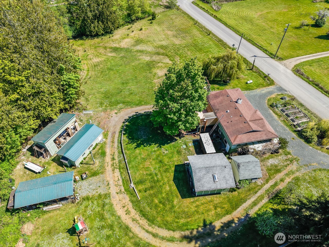63 East Arnette Road Port Angeles, WA 98362 - Photo 6 of 40 an aerial view of a house with a garden and trees