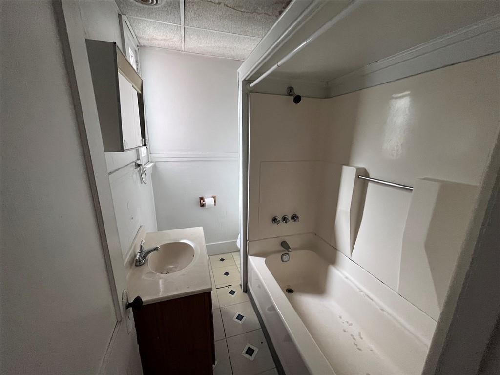 1123 Evergreen Road, Unit 2 Pittsburgh, PA 15209 - Photo 7 of 14 a bathroom with a tub sink and mirror