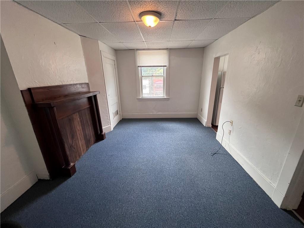 1123 Evergreen Road, Unit 2 Pittsburgh, PA 15209 - Photo 10 of 14 an empty room with windows and fireplace