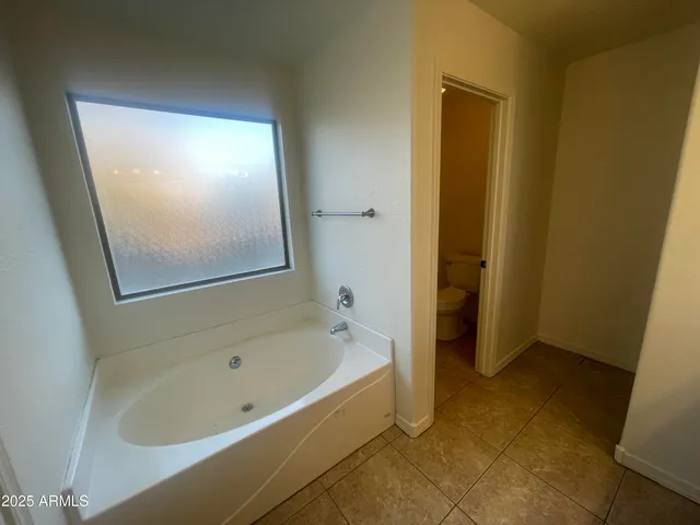 a bathroom with a bathtub and shower