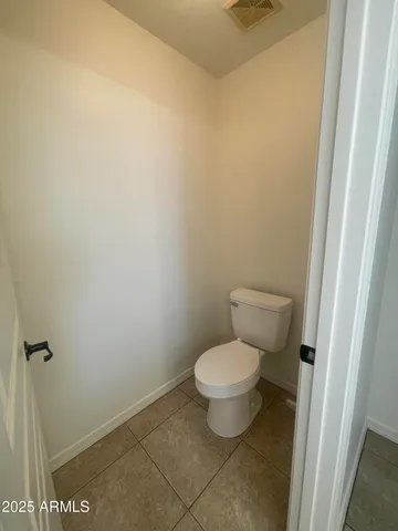 a white toilet sitting next to a shower